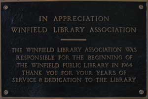 Plaque reading: In appreciation, Winfield Library Association. The Winfield Library Association was responsible for the beginning of the Winfield Public Library in 1964. Thank you for your years of service and dedication to the library.